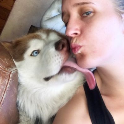 Sarah Tither-Kaplan kissing her dog